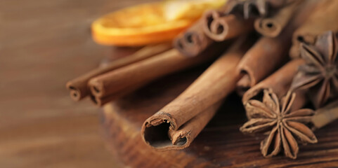 Aromatic cinnamon sticks on board, closeup