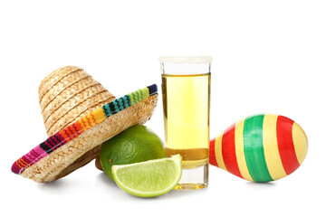 Decorative sombrero hat, maracas and shot of tequila with lime on white background