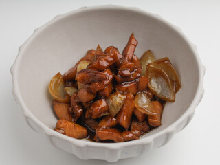 Chicken cooked in teriyaki sauce with onion in a bowl