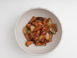 Chicken cooked in teriyaki sauce with onion in a bowl
