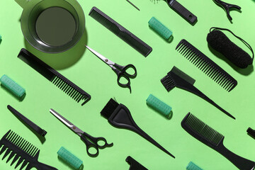 Set of hairdresser's accessories on green background