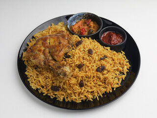 Biryani Rice served with fried chicken on a plate
