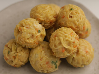 Takoyaki balls or noodle balls piled on a plate