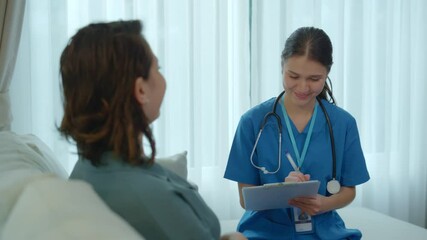 CaregiverHealthcare Professional in Blue Scrubs Engages in Compassionate Conversation with Patient, Showcasing Care and Support in Bright, Inviting Medical Setting
