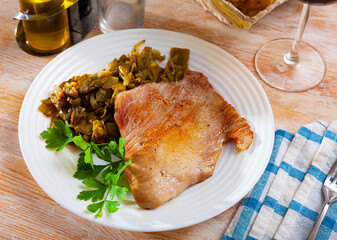 Fried Iberian pig served with beans and parsley