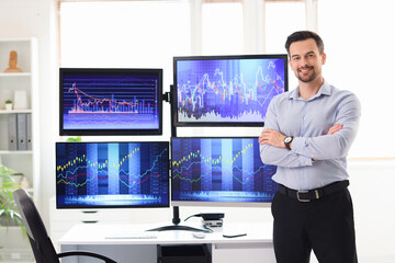 Portrait of male trader smiling in office