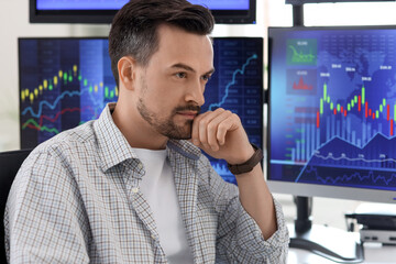 Thoughtful male trader sitting in office, closeup