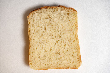 Slice of homemade white bread on white background