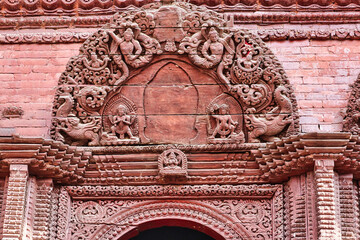 Artistic excellence in wooden carvings depicted as Yakshas,Gandharvas and other hindu mythology divine beings on the building facades on Kathmandu's durbar square,Nepal 