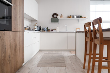 Interior of stylish light kitchen with modern furniture