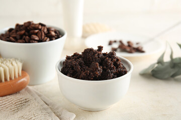 Composition with bowls of coffee body scrub and coffee beans on light grunge background