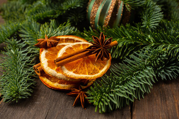 Dried oranges with spices on the rustic wooden background. Christmas mood. Selective focus. Shallow depth of field.