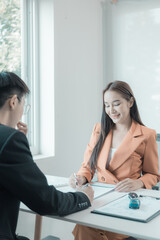 The person in question consults the car salesman with the purchase agreement for inspection at the showroom. The customer receives a vehicle purchase contract before signing with the dealer.
