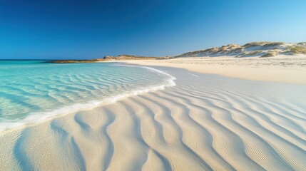 Tranquil Beach with Gentle Waves and Clear Blue Sky Above