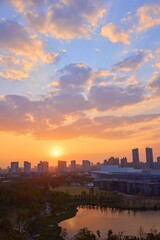 Vibrant sunset over greenhouse garden with city skyline and reflecting water