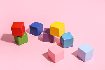 Colorful building blocks on pink background