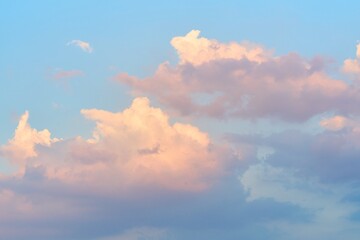 Stunning view of fluffy clouds against a clear blue sky during sunset, creating a serene and calming atmosphere