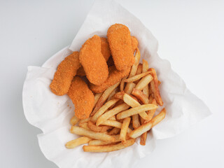 Chicken nugget and fries in white paper 