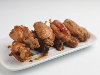 Grilled chicken wings on white rectangular plate