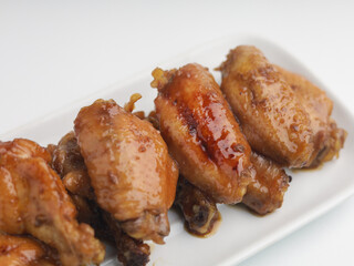 Grilled chicken wings on white rectangular plate