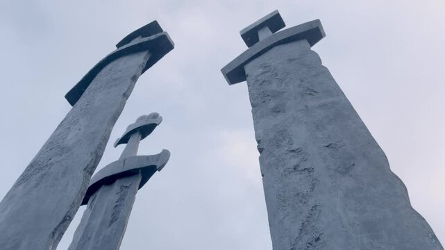 Down up shot of the Norwegian monument called Sverd i fjell that includes a slow pan in the movement.