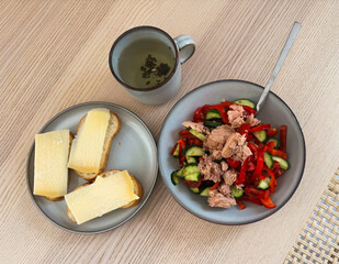 Delicious light lunch featuring fresh salad and sandwiches on a wooden table