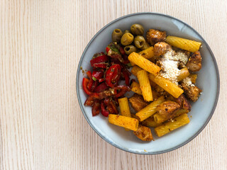 Delicious plate of pasta with seasoned chicken and fresh vegetables