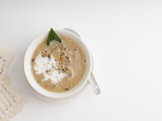 Mung bean porridge cooked with coconut milk and palm sugar in a bowl