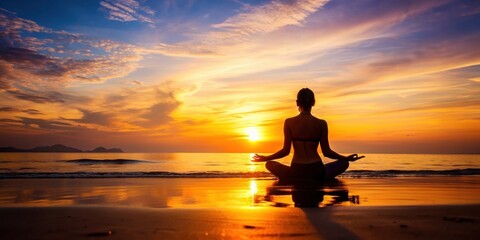 Fototapeta premium Silhouette of person meditating in lotus pose on the beach during a fiery sunset, meditation, yoga, lotus pose, beach