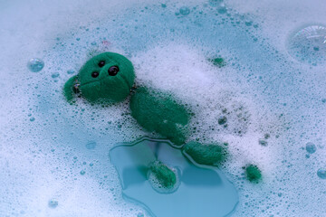 Soak the teddy bear in water soluble laundry detergent.