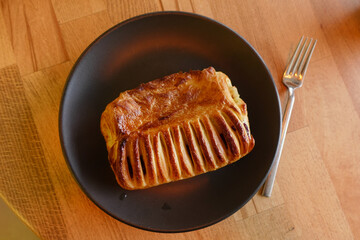 Freshly Baked Golden Pastry Served on a Dark Decorative Plate