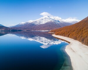 Fototapeta premium Snow-Capped Mountains Reflecting on Tranquil Lake Aerial View of Natural Serenity and Renewal