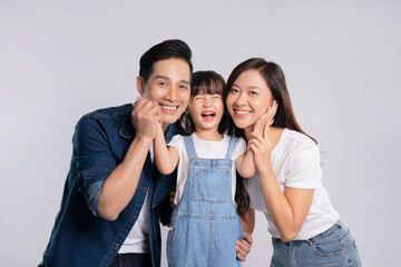 portrait  of a happy asian  family posing on a white background