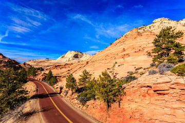 A road with a red stripe and a blue sky in the background