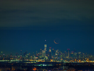 Manhattan view at night with crescent moon