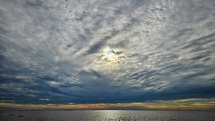 Sunrise with cloudy sliver sky at the sea landscape after rain season.