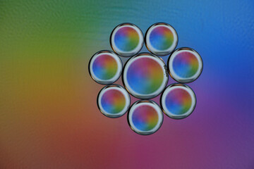 Rainbow-hued circular patterns on gradient background