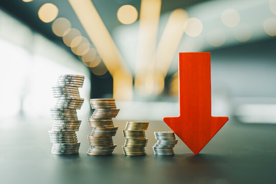 Down arrow with coin stack. concepts for success, methods, systems of raising or lowering Fed interest rates to correct inflation concepts.