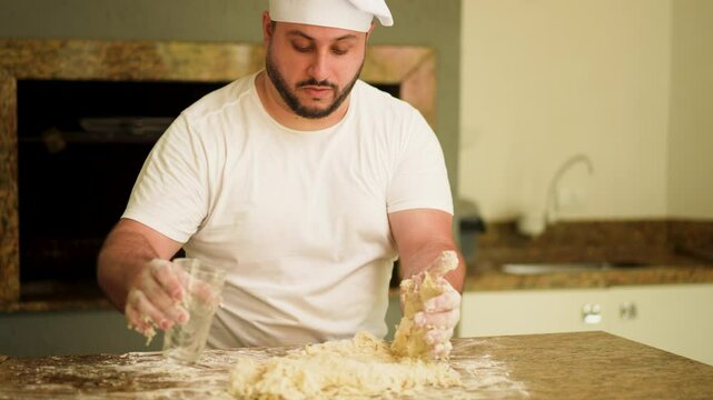 Hands-on moment asa chef pour water to flour on a countertop, showcasing the art of homemade pizza preparation