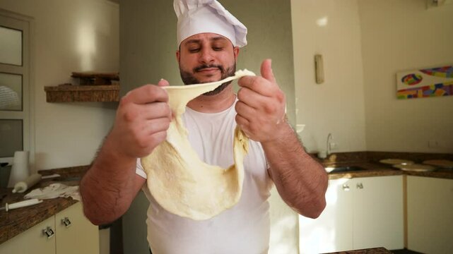 A close-up of a chef&rsquo;s expressive reaction as they examine unworkable dough in his hands