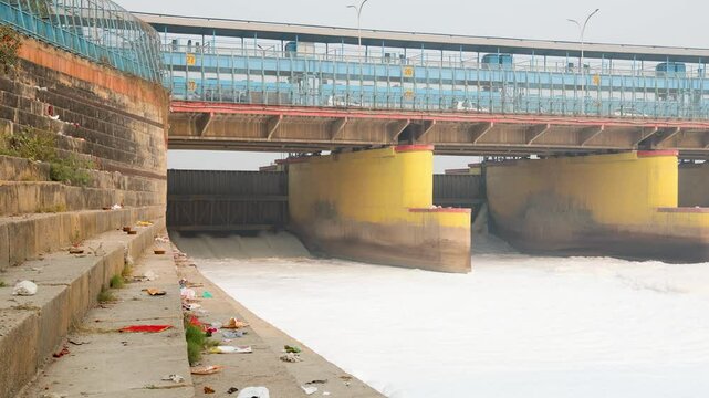 polluted river with industrial and domestic effluents toxic foam passing through barrage video is taken at yamuna river okhla barrage delhi india.