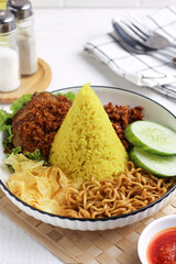 Cone shaped yellow rice or nasi tumpeng mini. Indonesian traditional cuisine for celebration. Perfect for recipe, article, catalogue, photo illustration, or any commercial purposes.