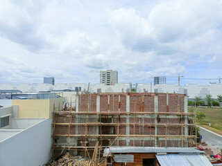 Jakarta, Indonesia - December 11, 2024: A building is under construction with two material trucks...