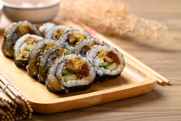 Gimbap or kimbap, Korean food made from cooked rice with vegetables, meat, egg and wrapped with...