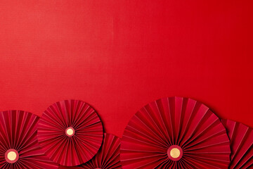 Traditional Chinese new year background concept, decorated with red paper fans on red background...