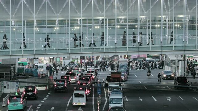 Tokyo Scene : People Walking on a Pedestrian Walkway Above Congested Major Urban Intersection at Dusk | Shibuya Station, Tokyo, Japan