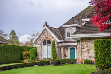 Fragment of  luxury house in fall with green trees and nice landscape in Vancouver, Canada, North America. Day time on November 2024.