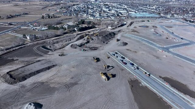 Aerial Payson Utah new home construction pull. Central Utah city. New home construction, heavy industrial earth moving equipment. Urban and rural landscape in mountain valley. 
