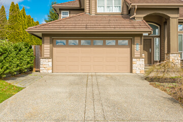 Garage door in luxury house with trees and nice landscape in Summer in Vancouver, Canada, North...