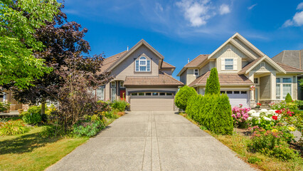Garage door in luxury house with trees and nice landscape in Summer in Vancouver, Canada, North America. Day time on June 2024.